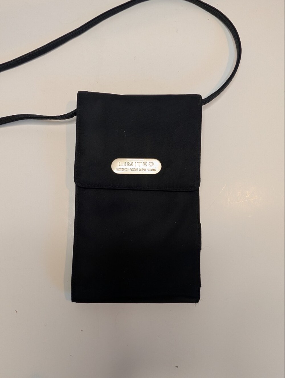 The Limited Black Crossbody Phone Pouch with Metal Logo Plate